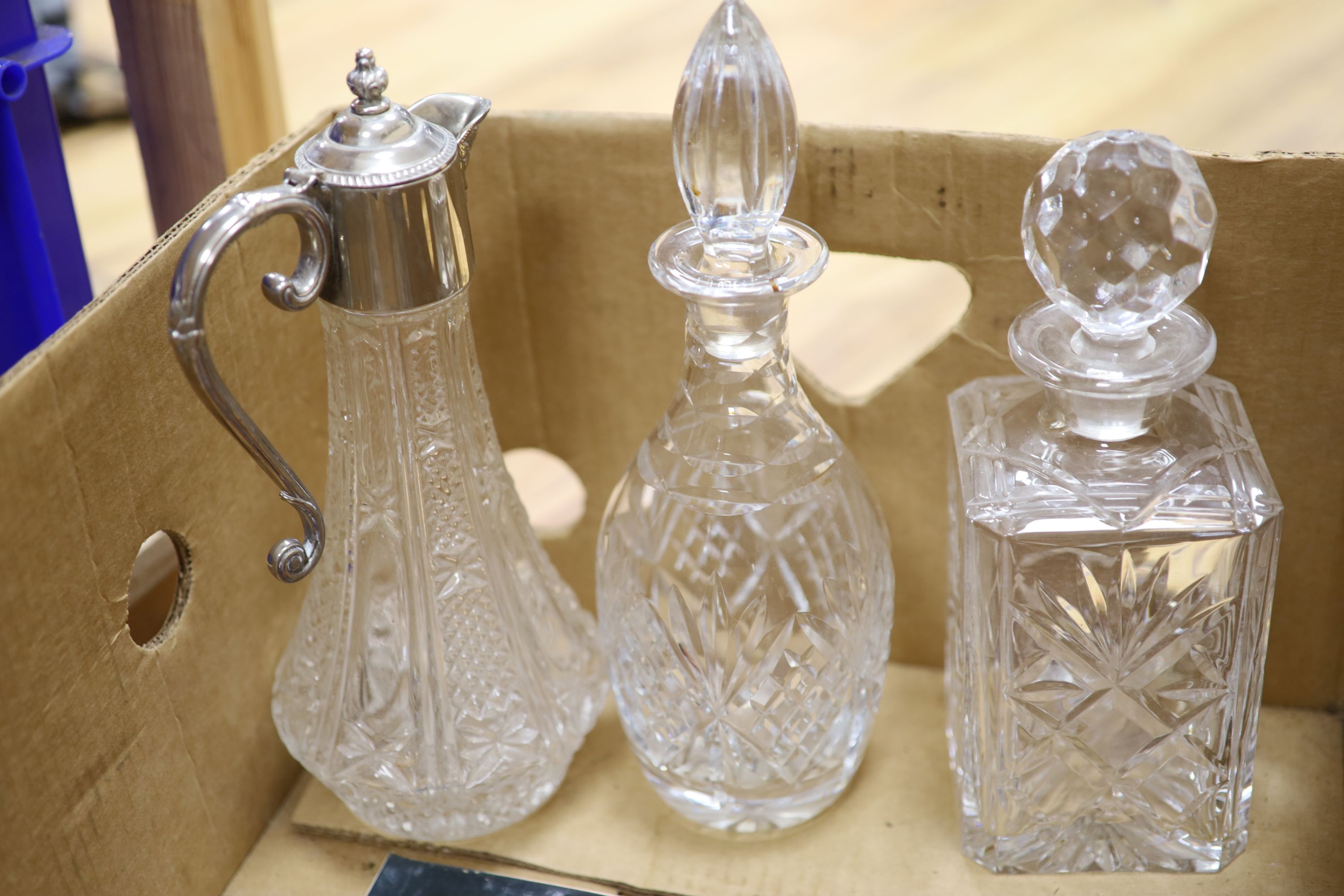 Five various glass decanters and a similar claret jug